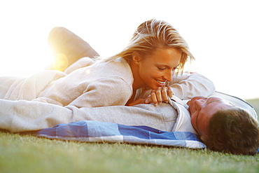 Couple lying down on picnic blanket