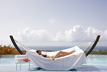 Woman relaxing in hammock