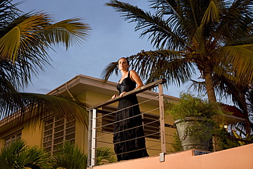 Woman standing on tropical balcony