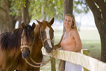 Woman posing with horses