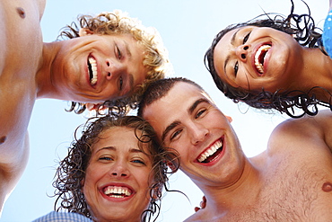 Low angle view of young friends in huddle