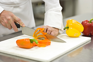 Chef chopping bell peppers