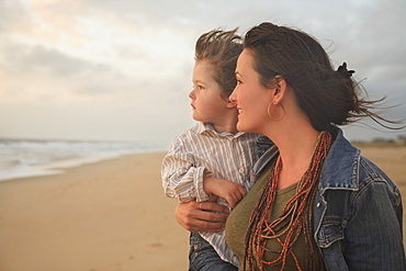 Mother holding son at beach