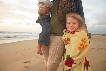 Mother and children walking on beach