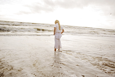 Girl standing in ocean surf