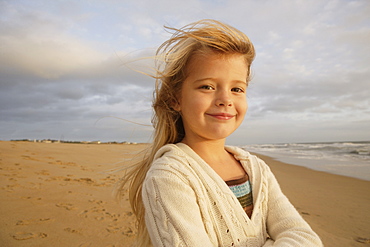 Girl with hair blowing at beach