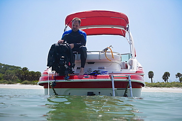 Man with scuba gear on boat, Florida, United States