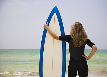 Girl holding surfboard, Florida, United States