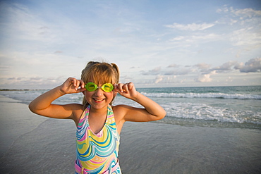 Girl wearing goggles at beach, Florida, United States