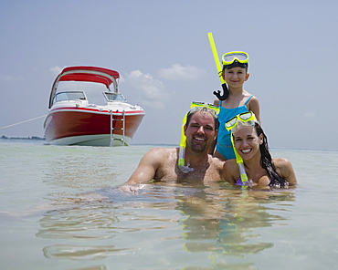 Family with snorkeling gear in water, Florida, United States