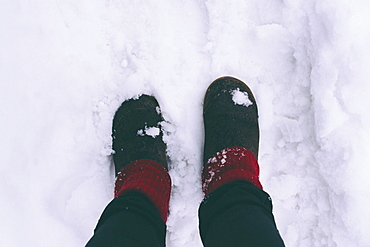 Woman standing on snow, low section