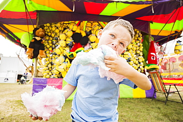 Boy (4-5) eating cotton candy in amusement park, USA, Utah, Salt Lake City 