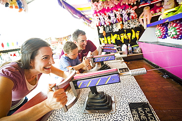 Happy Family with son (4-5) playing with water gun in amusement park, USA, Utah, Salt Lake City 