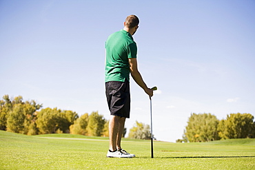 Rear view of man standing on golf course, Colorado, USA