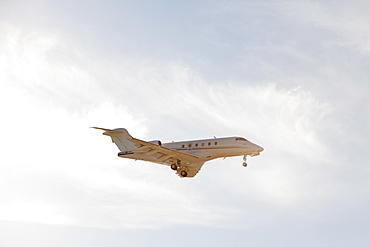 Private leer jet flying through air