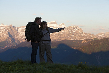 Switzerland, Leysin, Hikers looking at view of Alps, Switzerland, Leysin