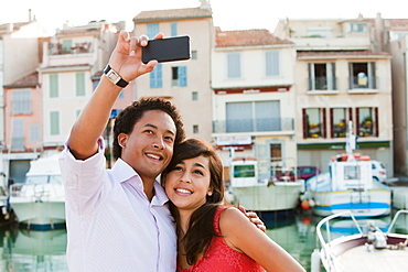 France, Cassis, Couple taking picture with smartphone, France, Cassis
