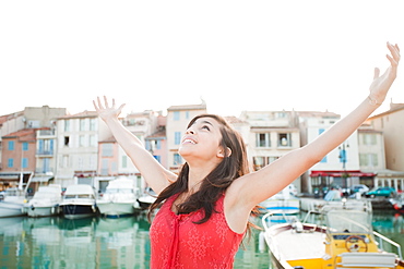 France, Cassis, Portrait of young woman with arms spread, France, Cassis