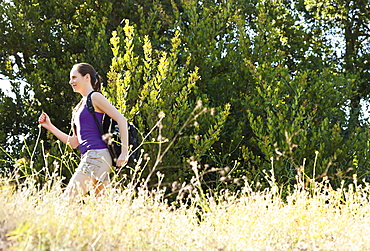 Woman running through meadow, USA, California, Los Angeles