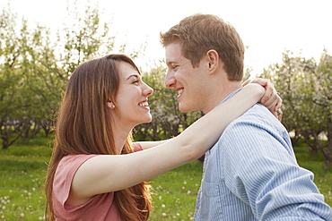 USA, Utah, Provo, Young couple embracing in orchard