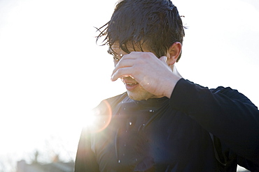 Man in sports clothing back lit by sun