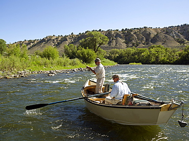 USA, Colorado, Pair of men fly-fishing on mountain river