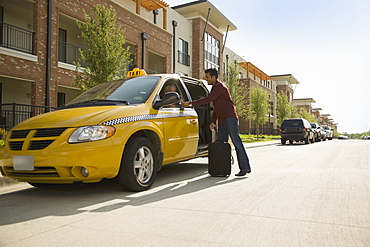 USA, Texas, Dallas, Man alighting from taxi