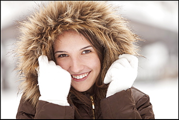 USA, Utah, Lehi, Portrait of young woman wearing fur hooded coat