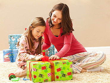 Two sisters (6-7, 18-19) preparing Christmas presents