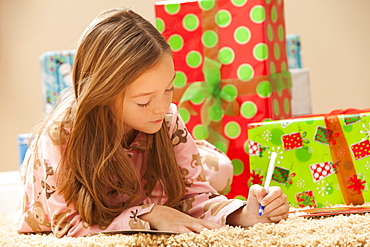 Girl (6-7) preparing Christmas presents