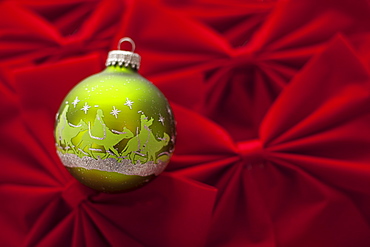 Studio Shot of red velvet bows with green Christmas ornament