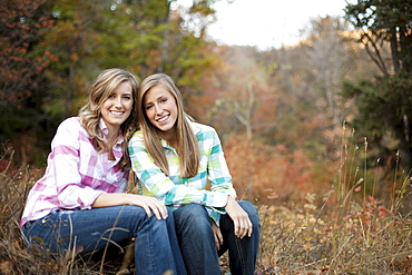 USA, Utah, Sundance, Portrait of two young women sitting on meadow