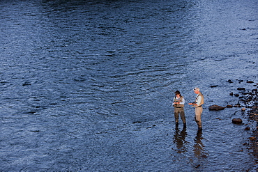 Canada, British Columbia, Fernie, Couple fly fishing in river