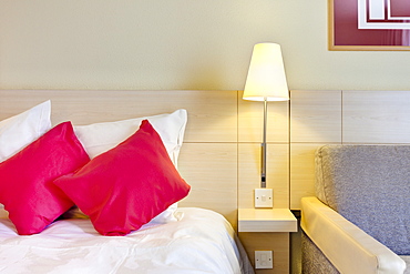 Electric lamp beside bed in luxury home