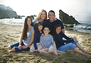 Family sitting together at the beach