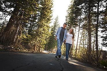 Couple walking hand in hand on a country road