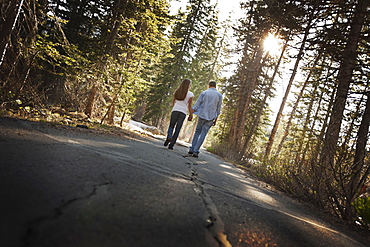 Couple walking hand in hand on a country road