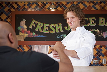 Bartender and customer at juice bar