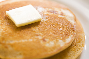 Pancakes and butter on plate