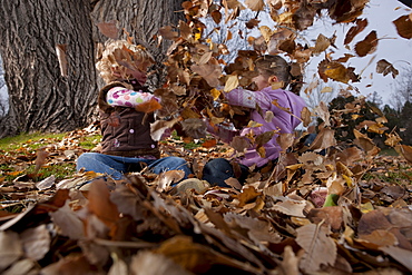 Girls playing in leaves