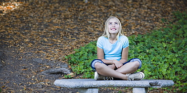 Young girl sitting on bench