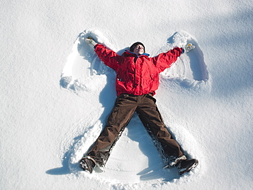 Woman making snow angel