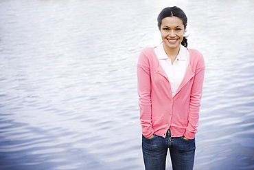 Portrait of woman smiling by sea