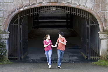 Young couple running through tunnel