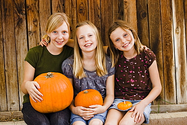 Girls holding pumpkins