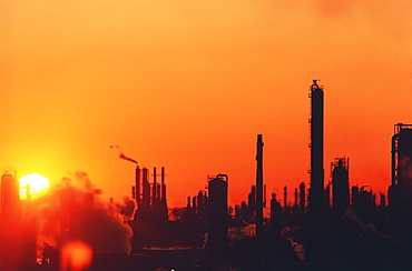 Sun setting on oil refinery in Baytown, Texas