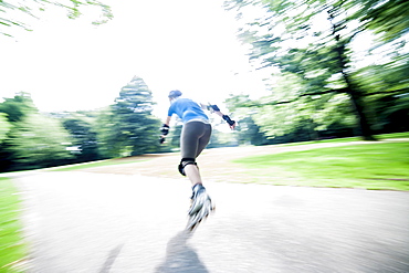 Woman roller skating in park, Netherlands