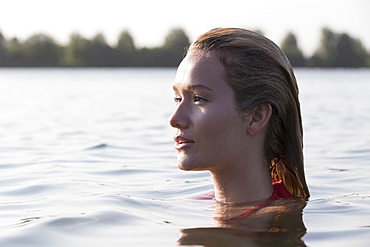 Woman relaxing in lake, Profile, Netherlands, Gelderland, De Rijkerswoerdse Plassen