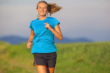 Front view of young woman jogging, Kalispell, Montana, USA