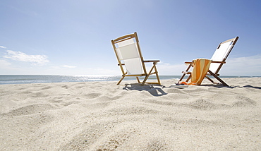 Sun chairs on sandy beach